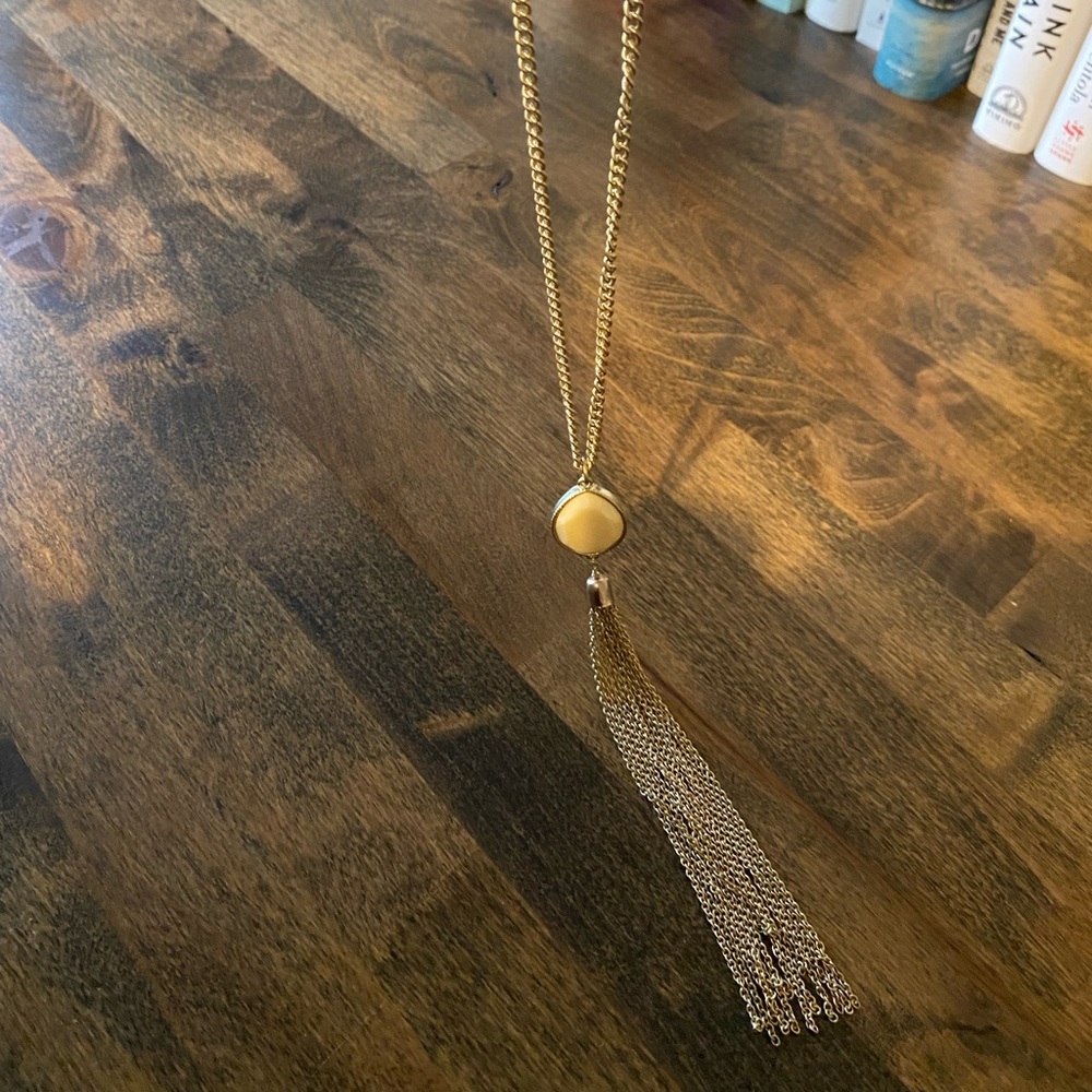 Banana republic long necklace, gold with ivory colored stone.